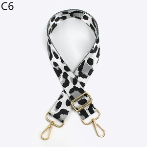 Detail of adjustable leopard print bag strap with polished gold-tone metal lobster hooks