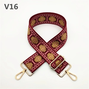 Detail view of thickened wine red ethnic style purse strap with golden lobster clasp