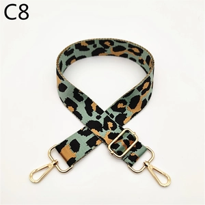 Detail of adjustable leopard print bag strap with golden metal lobster clasps and buckle