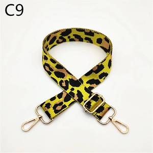 Detail view of leopard print bag strap with adjustable gold alloy buckles on white backdrop