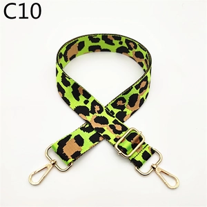 Close-up of leopard print bag strap with green background and gold lobster clasps