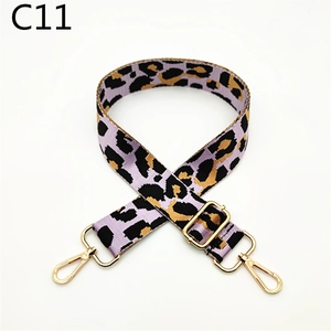 Detail view of adjustable purple leopard print bag strap with golden metal hardware