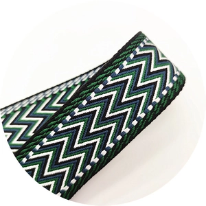 Macro detail of bohemian woven adjustable thick bag strap with geometric patterns