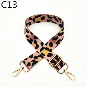 Macro detail of adjustable leopard print bag strap with golden metal swivel hooks
