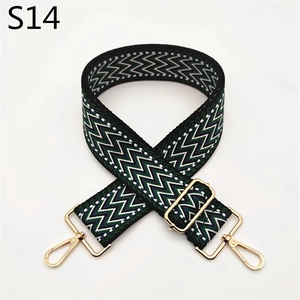 Macro detail of wave pattern woven bag strap with adjustable gold metal hardware