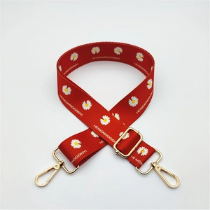 Detail of red floral woven replacement strap with golden metal lobster clasps for handbags