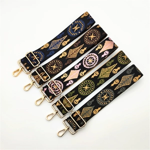 Five ethnic jacquard handbag straps with golden metal buckles on white background