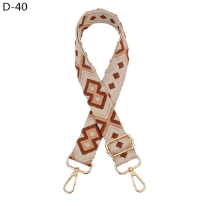 Detail of adjustable geometric diamond weave bag strap with gold metal lobster clasp