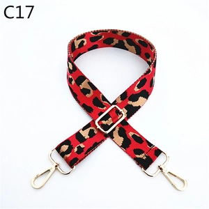 Detail view of leopard print woven bag strap with adjustable gold lobster metal buckles