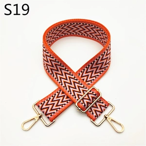 Detail of adjustable orange and black chevron woven strap with gold metal lobster clasps