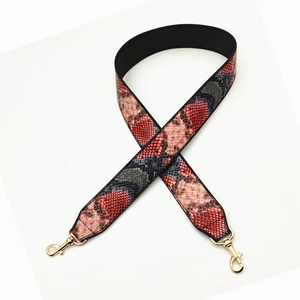 Wide snakeskin pattern bag strap replacement with red and black python print and gold buckles
