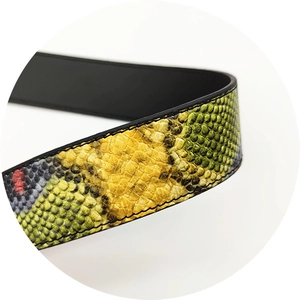 Detail of snake skin pattern PU bag strap showing colorful scale texture and stitching