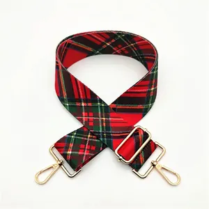 Adjustable red and green plaid canvas bag strap with gold metal hooks and buckle
