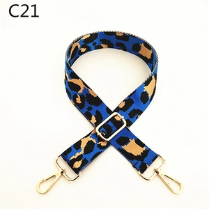 Detail of blue leopard print replacement bag strap with golden metal lobster clasps