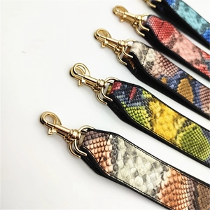 Close-up of multicolored snakeskin texture PU leather straps with gold lobster clasps