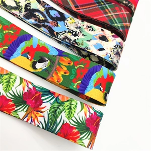 Detail of colorful canvas shoulder straps featuring tropical parrot and floral patterns