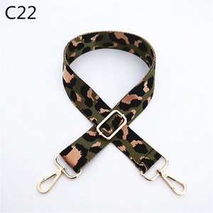 Close-up of leopard print bag strap with adjustable gold buckle and metal swivel hooks