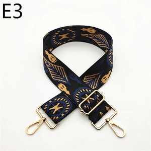 Detail of wide ethnic pattern bag strap with gold metal lobster clasps and buckles