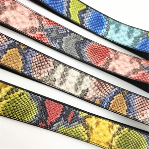 Close-up of colorful snakeskin textured PU leather bag straps with scale patterns