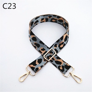 Detail of adjustable leopard print bag strap with golden metal lobster clasps