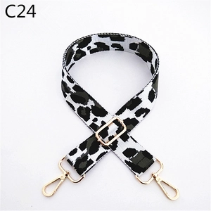 Detailed view of leopard print bag strap with adjustable buckle and gold metal hooks