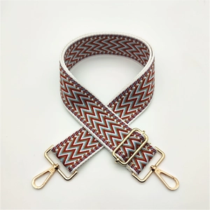 Adjustable jacquard shoulder strap with red and blue wavy pattern and gold metal hooks