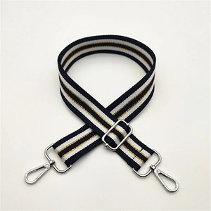 Adjustable striped canvas bag strap with navy and gold patterns and silver metal hooks