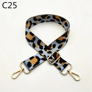 Close-up of leopard print bag strap with golden metal hooks and adjustable buckle