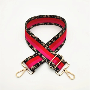 Adjustable canvas shoulder strap with colorful camo and pink stripes and gold hardware