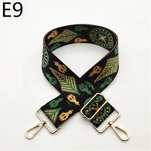 Close-up of ethnic woven handbag strap with geometric patterns and gold swivel hooks