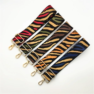 Adjustable striped canvas straps with zebra patterns and gold metal hooks for handbags