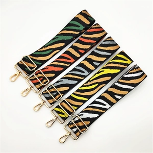 Detail of five adjustable zebra pattern replacement straps with gold metal buckles