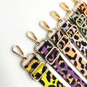 Detail of adjustable leopard print bag straps with shiny gold lobster clasps