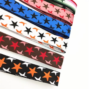 Close-up of woven bag straps with star patterns in navy, pink, beige, brown, and black