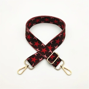 Macro detail of adjustable star pattern bag strap with premium gold metal hooks