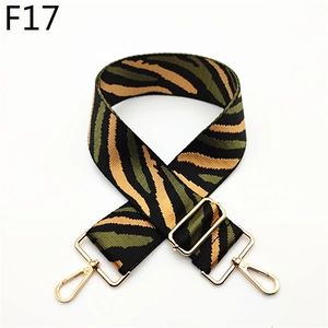 Detail of adjustable tiger stripe canvas strap with gold metal hooks and buckle
