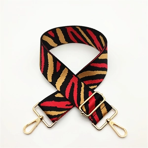 Adjustable wide canvas shoulder strap with red and black tiger stripes and gold metal hooks