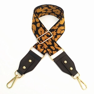 Adjustable leopard print bag strap with golden metal clasps and animal pattern weave