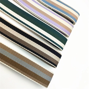 Detailed view of multiple thick woven striped shoulder straps in various color patterns