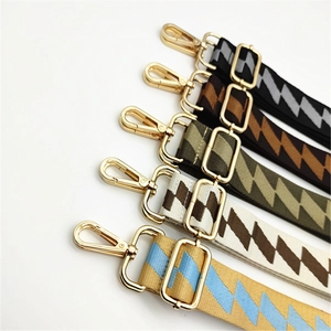 Detail view of five geometric pattern bag straps with gold metal lobster clasps