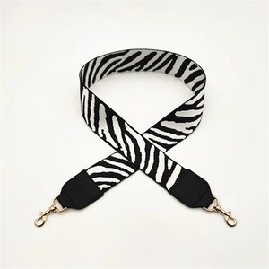 Zebra print fabric bag strap with black leather ends and gold metal lobster clasps