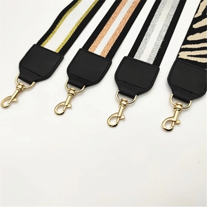 Close-up of sparkling striped replacement bag straps with premium gold metal clasps