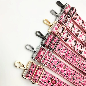 Detail of floral wide replacement bag straps with gold, silver, and gunmetal hardware