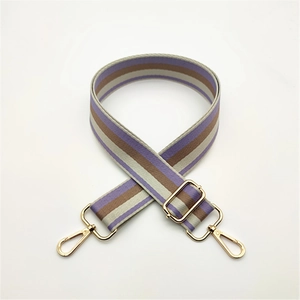 Adjustable striped woven purse strap with purple and brown patterns and gold hardware