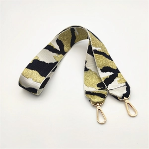 Detail der dicken Camo-Webgurte und goldener Karabinerverschlüsse für Handtaschen