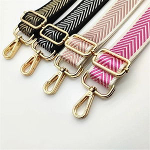 Adjustable woven shoulder straps with herringbone pattern and gold metal hooks