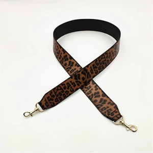 Close-up of leopard print PU leather shoulder strap with golden metal swivel snap hooks