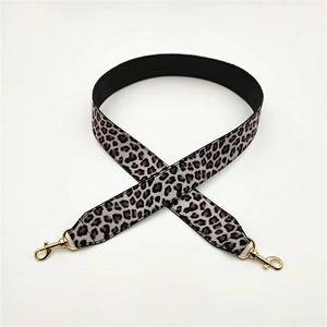 Close-up of leopard print PU strap with golden lobster clasps and thick webbing texture