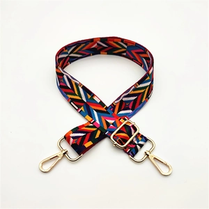 Adjustable geometric patterned shoulder strap with gold metal swivel hooks and buckles