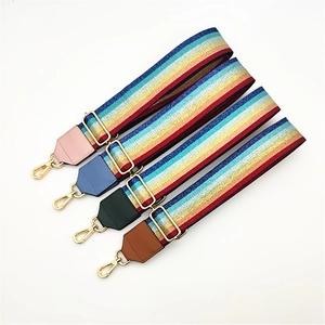 Colorful striped fabric bag straps with leather accents and golden metal hardware